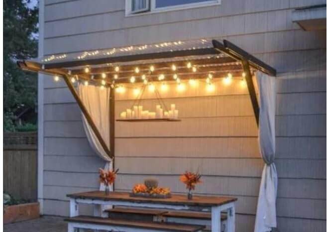 partial DIY outdoor canopy tent alongside house